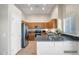 Kitchen featuring stainless steel appliances, wooden cabinets, and a breakfast bar with solid surface countertop at 8178 W Tonopah Dr, Peoria, AZ 85382