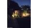 Serene backyard at night with ambient lighting, lush greenery and a stone pathway at 8259 W Carol Ave, Peoria, AZ 85345