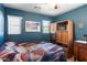 Cozy bedroom with a large bed, wooden accents, and windows for natural light at 8259 W Carol Ave, Peoria, AZ 85345