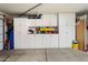 Organized garage with ample white cabinetry and counter space for storage and projects at 8259 W Carol Ave, Peoria, AZ 85345
