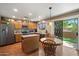 Eat-in kitchen featuring wood cabinets, granite countertops, and stainless steel appliances at 8259 W Carol Ave, Peoria, AZ 85345