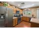 Well-equipped kitchen with stainless steel appliances, wood cabinets, and a view of the backyard at 8259 W Carol Ave, Peoria, AZ 85345