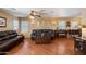 Inviting living room featuring wood floors, comfortable leather seating, and a piano at 8259 W Carol Ave, Peoria, AZ 85345