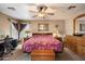 Comfortable main bedroom features a ceiling fan, and a dresser with mirror at 8259 W Carol Ave, Peoria, AZ 85345