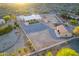 Expansive desert property featuring a ranch home, generous outdoor space, storage sheds, and a white-fenced boundary at 8351 S Summit Dr, Casa Grande, AZ 85193