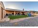 Backyard view of this house featuring an artificial grass play area, patio furniture, and desert landscaping at 8351 S Summit Dr, Casa Grande, AZ 85193