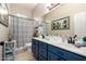 Bathroom with double sinks, blue vanity, updated mirror, and beach themed decor at 8351 S Summit Dr, Casa Grande, AZ 85193
