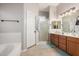 Bathroom featuring a soaking tub, a walk-in shower, and wood-grain cabinets at 8351 S Summit Dr, Casa Grande, AZ 85193