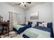 Bedroom featuring two beds, a ceiling fan, and a large window at 8351 S Summit Dr, Casa Grande, AZ 85193