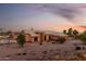 Inviting single-story home featuring a well-manicured front yard and neutral-toned exterior at sunset at 8351 S Summit Dr, Casa Grande, AZ 85193