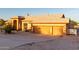 Charming home features a 2-car garage and stone landscaping with an expansive driveway at 8351 S Summit Dr, Casa Grande, AZ 85193