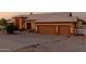 Charming home features a 2-car garage and stone landscaping with an expansive driveway at 8351 S Summit Dr, Casa Grande, AZ 85193