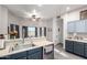 Bright kitchen with stainless steel appliances, gray cabinets, and large windows offering natural light at 8351 S Summit Dr, Casa Grande, AZ 85193