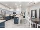 Modern kitchen with stainless steel appliances, island, and open dining area at 8351 S Summit Dr, Casa Grande, AZ 85193