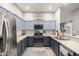 Well-lit kitchen featuring stainless steel appliances, gray cabinets, and a mosaic tile backsplash at 8351 S Summit Dr, Casa Grande, AZ 85193