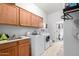 Laundry room features sink, tile floors, cabinets, and washer and dryer at 8351 S Summit Dr, Casa Grande, AZ 85193