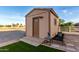 Exterior view of the shed, showcasing its door, window, landscaping, and proximity to the main house at 8351 S Summit Dr, Casa Grande, AZ 85193