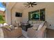Elegant backyard with covered patio, outdoor seating, and a large sliding glass door at 883 E Hampton Ln, Gilbert, AZ 85295