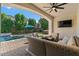 Inviting backyard with covered patio, lush landscaping, pool, and outdoor seating at 883 E Hampton Ln, Gilbert, AZ 85295
