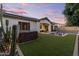 Beautiful backyard featuring a hot tub, pool, lounge chairs, and well-manicured artificial grass at 883 E Hampton Ln, Gilbert, AZ 85295