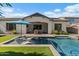 Relaxing backyard view with a shimmering pool, submerged loungers, and covered outdoor living space at 883 E Hampton Ln, Gilbert, AZ 85295