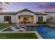 Lovely backyard showcasing a pool with lounge chairs, covered patio, and lush landscaping at 883 E Hampton Ln, Gilbert, AZ 85295