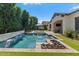 Serene backyard with pool, spa, fire pit, and covered patio, ideal for entertaining at 883 E Hampton Ln, Gilbert, AZ 85295