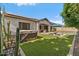 Spacious backyard featuring a refreshing pool, hot tub, lush lawn, and desert landscaping elements at 883 E Hampton Ln, Gilbert, AZ 85295