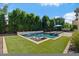 Lush backyard with mature trees, pool, and outdoor lounge chairs, perfect for relaxation at 883 E Hampton Ln, Gilbert, AZ 85295