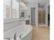 Bright bathroom featuring a soaking tub, walk-in shower, and a neutral color palette at 883 E Hampton Ln, Gilbert, AZ 85295