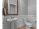 Charming bathroom featuring pedestal sink, toilet and decorative mirror at 883 E Hampton Ln, Gilbert, AZ 85295