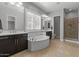 Bright bathroom showcasing a soaking tub, walk-in shower and dual sink vanities at 883 E Hampton Ln, Gilbert, AZ 85295