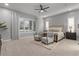 Spacious bedroom with neutral tones, plush carpet, and ample natural light through shuttered windows at 883 E Hampton Ln, Gilbert, AZ 85295