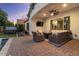 Outdoor living space featuring a covered patio with comfortable seating and a beautiful view of the pool and backyard at 883 E Hampton Ln, Gilbert, AZ 85295