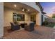 Covered patio with outdoor seating area and a fire pit great for entertaining at 883 E Hampton Ln, Gilbert, AZ 85295