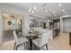 Bright dining area boasts a glass table, natural light, and easy access to the outdoor patio at 883 E Hampton Ln, Gilbert, AZ 85295