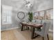 Bright dining room with tile flooring, shuttered windows, and modern light fixture at 883 E Hampton Ln, Gilbert, AZ 85295