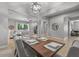 Open concept dining area with decorative light fixture, table for six, and tile floors at 883 E Hampton Ln, Gilbert, AZ 85295