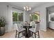 Bright dining area features a glass table, backyard views, and flows seamlessly to the outdoor living space at 883 E Hampton Ln, Gilbert, AZ 85295
