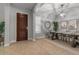 Inviting entryway with tile flooring, decorative mirror, and a solid wood front door at 883 E Hampton Ln, Gilbert, AZ 85295