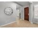 Inviting entryway with tile flooring, decorative mirror, and a solid wood front door at 883 E Hampton Ln, Gilbert, AZ 85295