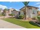Charming single-story home with manicured lawn, paver driveway, and desert landscaping at 883 E Hampton Ln, Gilbert, AZ 85295