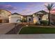 Charming single-story home featuring a three-car garage, lush landscaping, and inviting curb appeal at 883 E Hampton Ln, Gilbert, AZ 85295