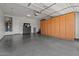 Spacious garage with epoxy floor, built-in storage cabinets, and ample workspace at 883 E Hampton Ln, Gilbert, AZ 85295
