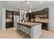 Spacious kitchen featuring stainless steel appliances, granite countertops and seating at kitchen island at 883 E Hampton Ln, Gilbert, AZ 85295