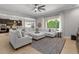 Bright living room featuring a plush white sectional sofa and large window at 883 E Hampton Ln, Gilbert, AZ 85295