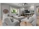 Cozy living room featuring a plush white sectional sofa and large window at 883 E Hampton Ln, Gilbert, AZ 85295