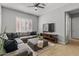 Comfortable living room with a sectional sofa, window shutters and stylish decor at 883 E Hampton Ln, Gilbert, AZ 85295