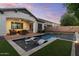 Stunning backyard showcasing a pool with lounge chairs, covered patio, and lush landscaping at dusk at 883 E Hampton Ln, Gilbert, AZ 85295