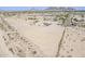 Wide aerial shot of a property in a desert landscape, showcasing its generous yard and location at 8912 N Johnson Ct, Maricopa, AZ 85139